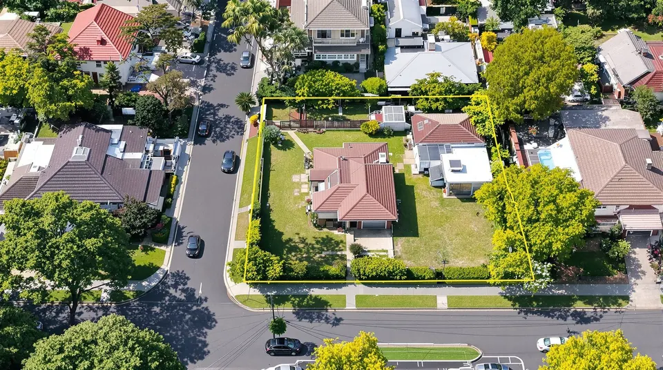Aerial view of a wide suburban block with its boundary outlined