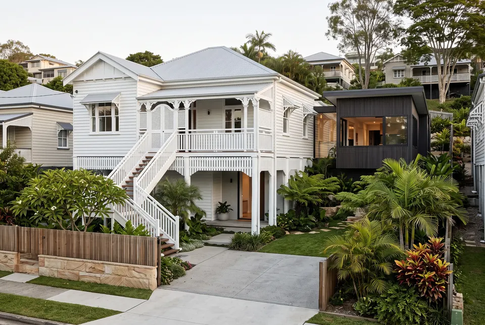 Renovated Paddington Queenslander on stumps with a new dark timber pavilion beside it