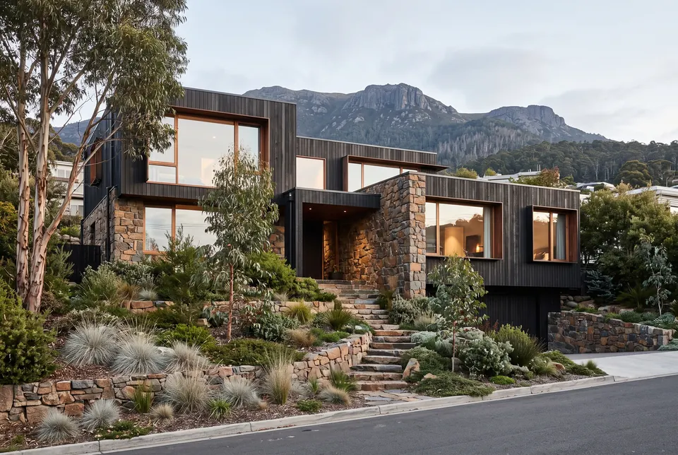 Sandy Bay residence in charred timber and dolerite stone with kunanyi / Mount Wellington behind